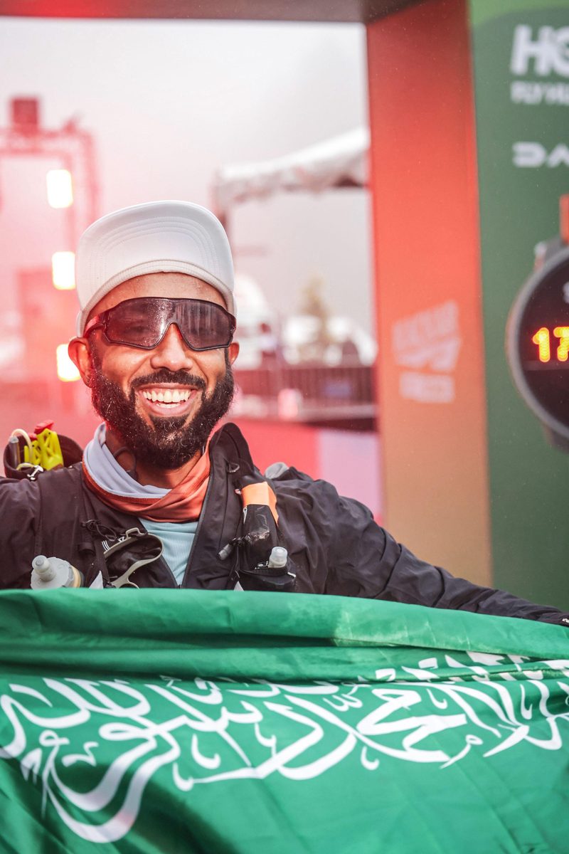 Smiling at finish with Saudi flag
