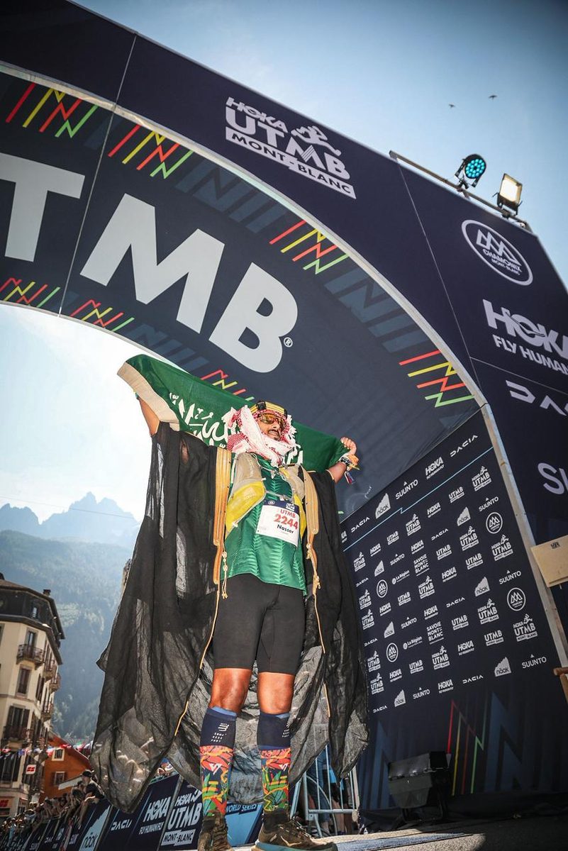 Nasser at UTMB arch with Saudi flag